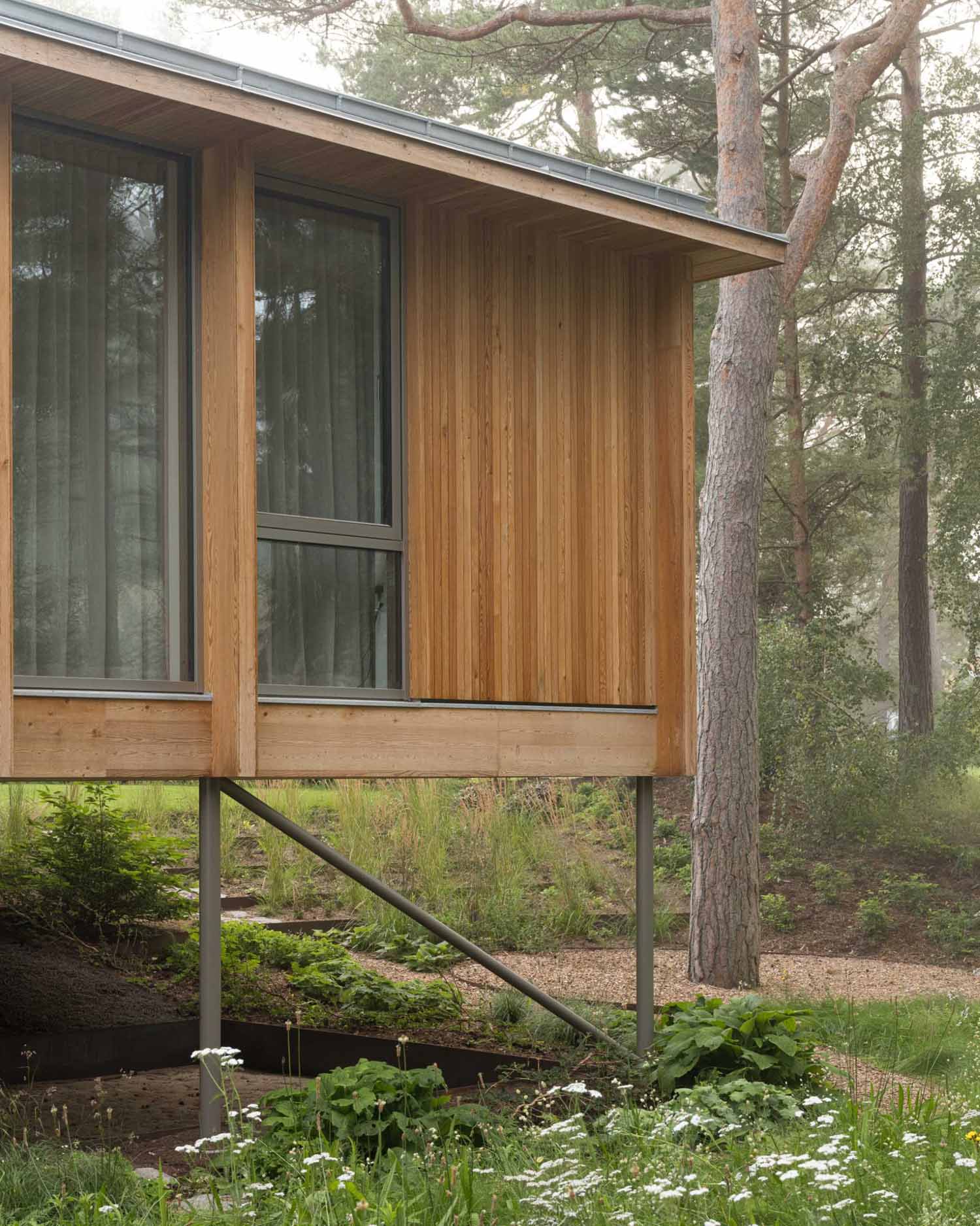 An elevated summer home clad in larch wood.