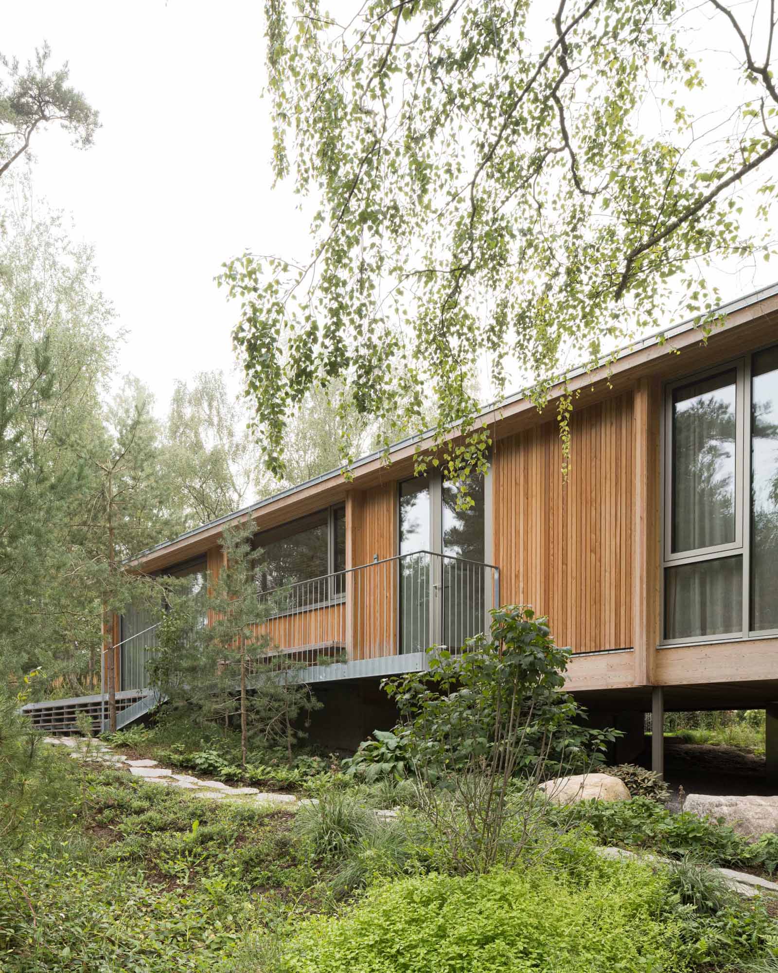 An elevated summer home clad in larch wood.