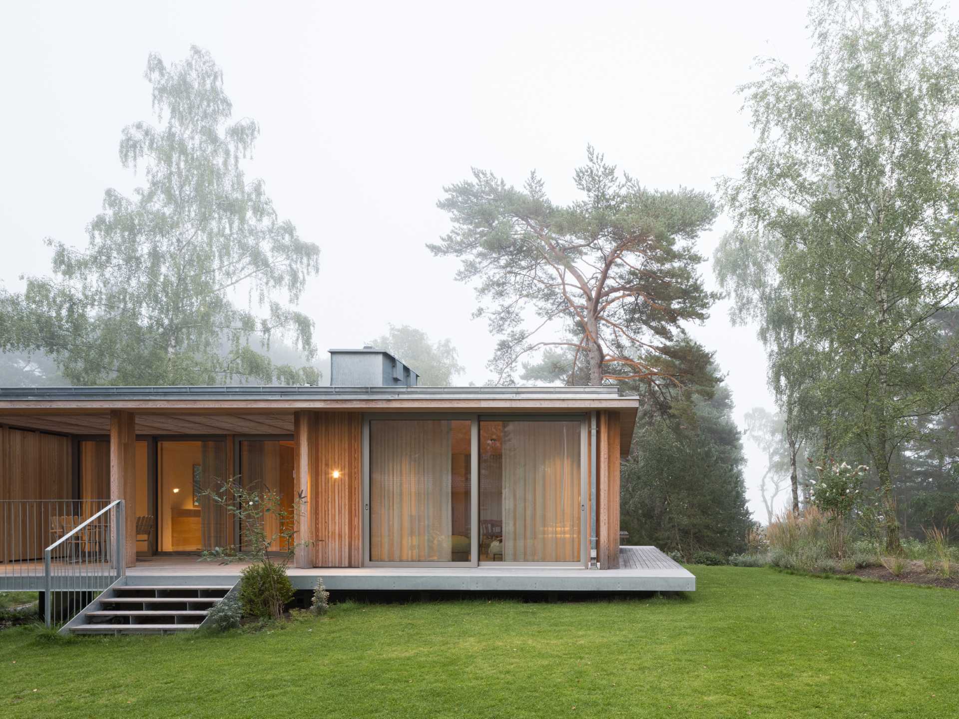 An elevated summer home clad in larch wood.