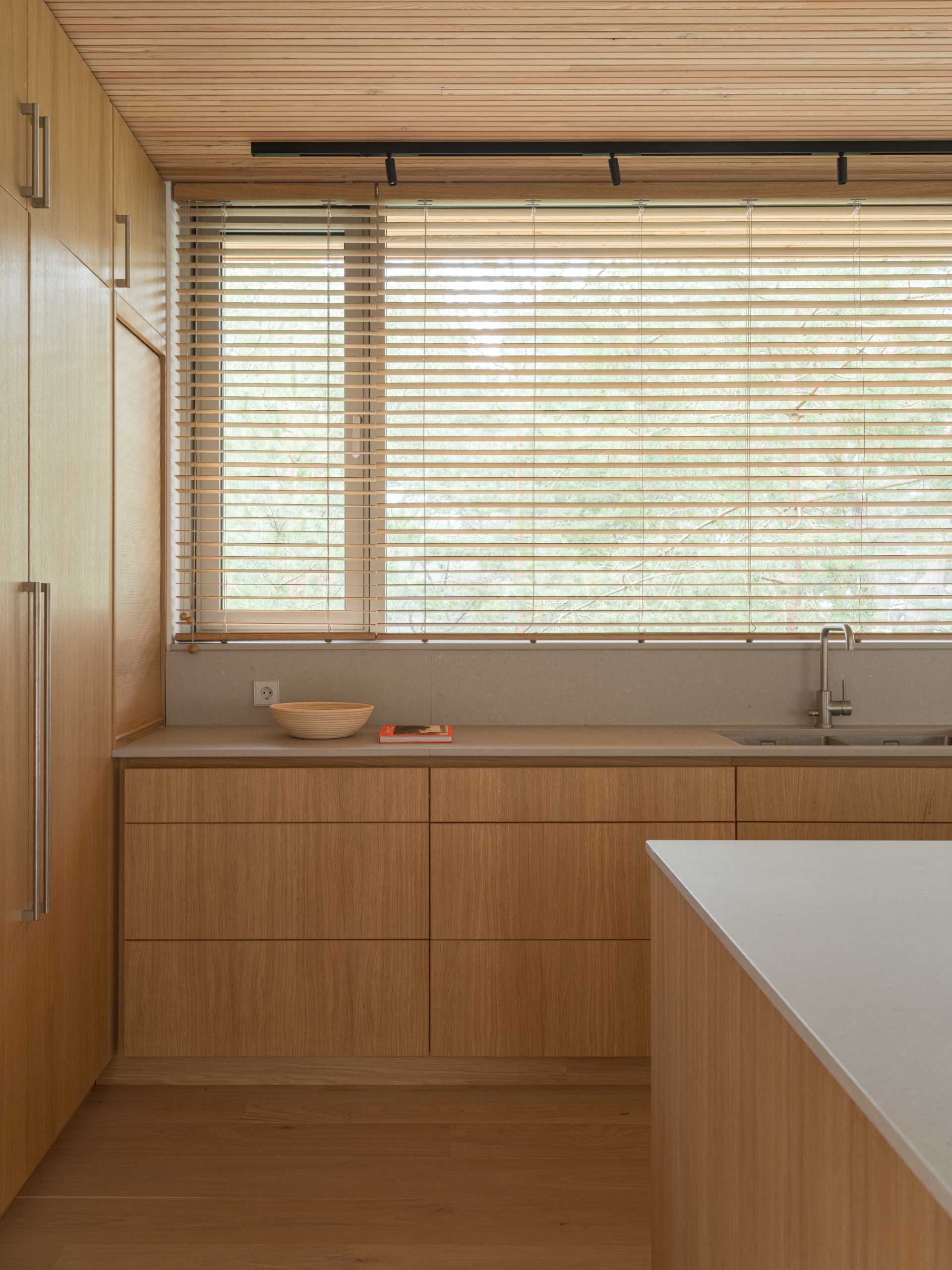 A modern kitchen with wood cabinets.