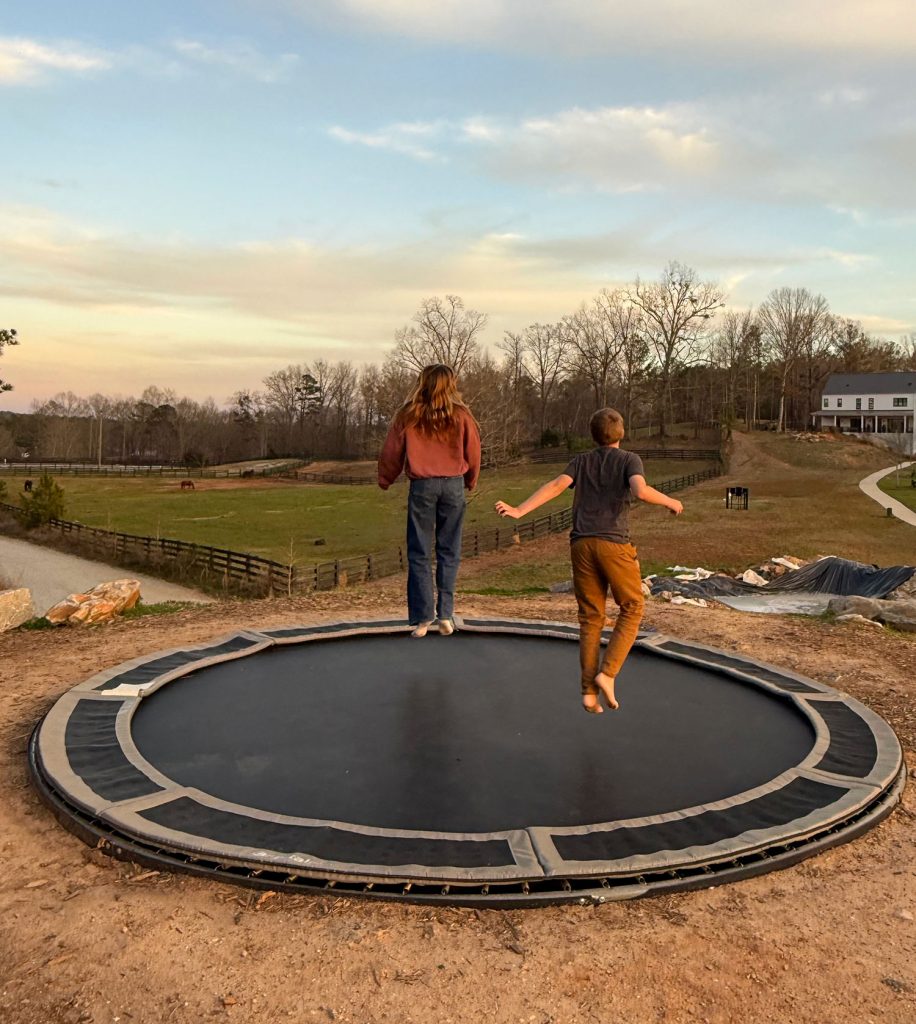 Kids Jumping On In Ground Trampoline in Serenbe Georgia